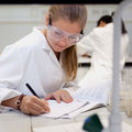 An image of a student making calculations on paper