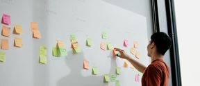 An ITP student brainstorming with post-it notes