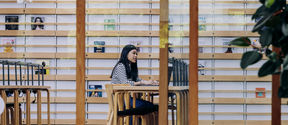 Student sitting in the Learning Centre reading room.