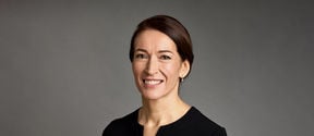 A portrait image of Suzanne Innes-Stubb, she smiles and gaze is towards the camera