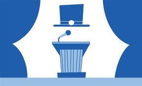 Doctoral hat floating above a speaker's podium with a microphone