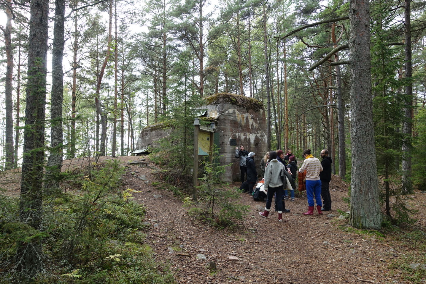 Students gather outside an old military bunker, in the middle of a forest, on the island of Reposaari