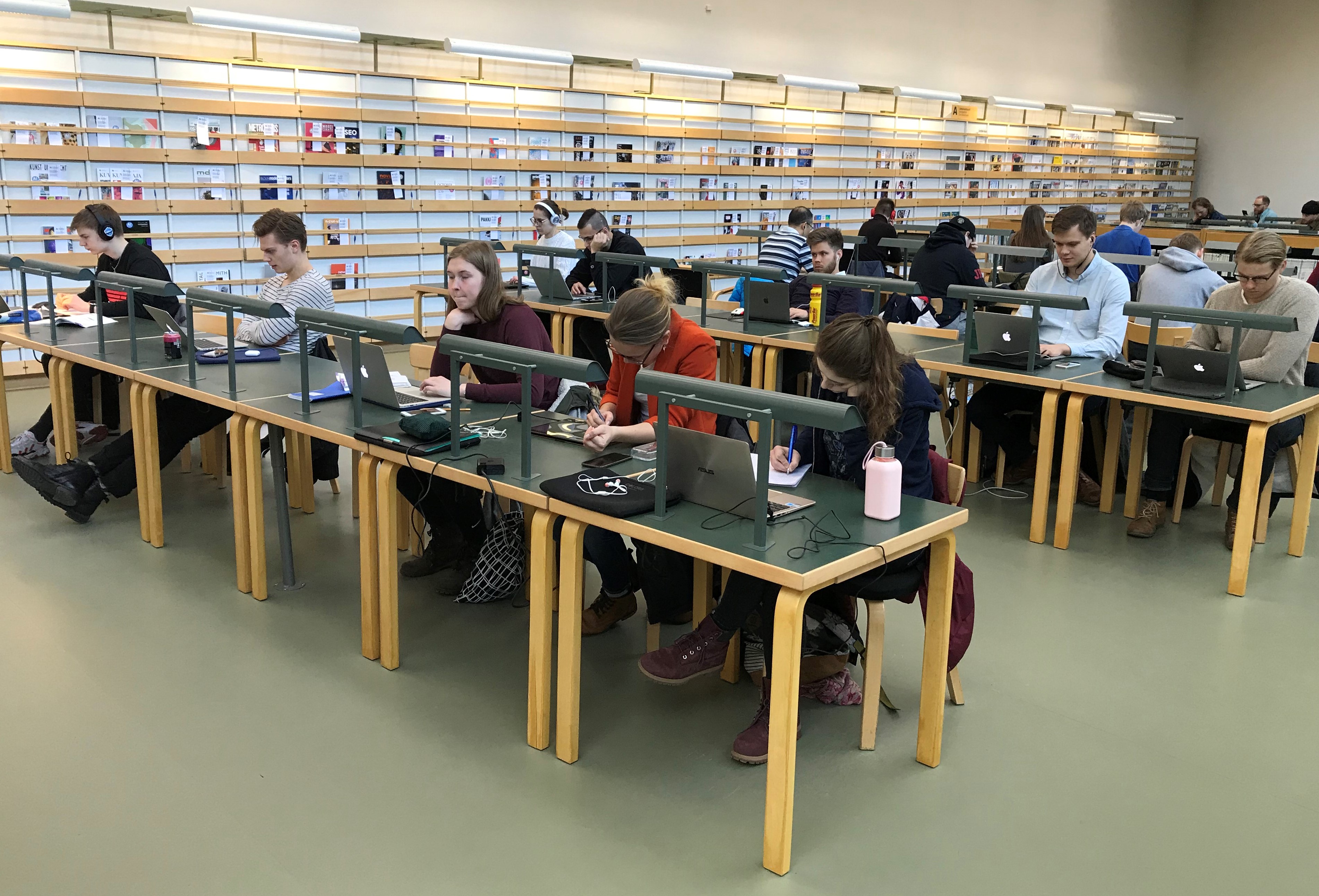Kuva opiskelijoista opiskelemassa Oppimiskeskuksen 2. kerroksessa, lehtilukusalissa.