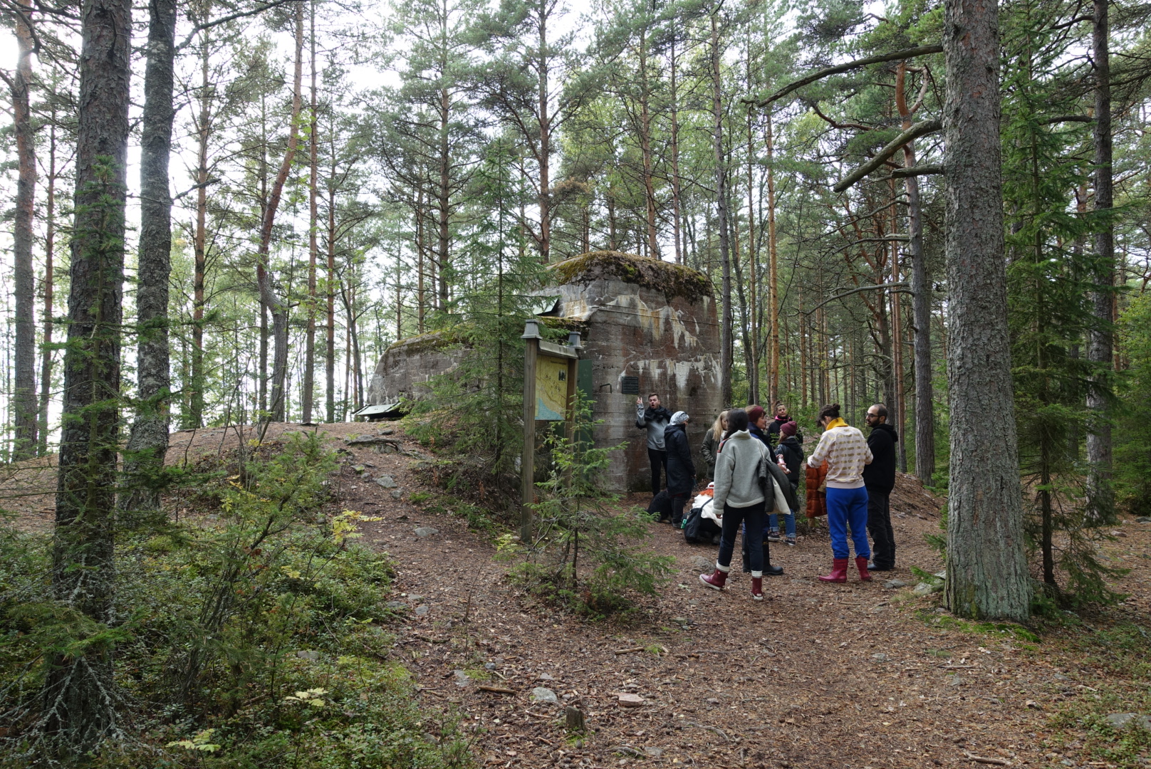 Students gather outside an old military bunker, in the middle of a forest, on the island of Reposaari