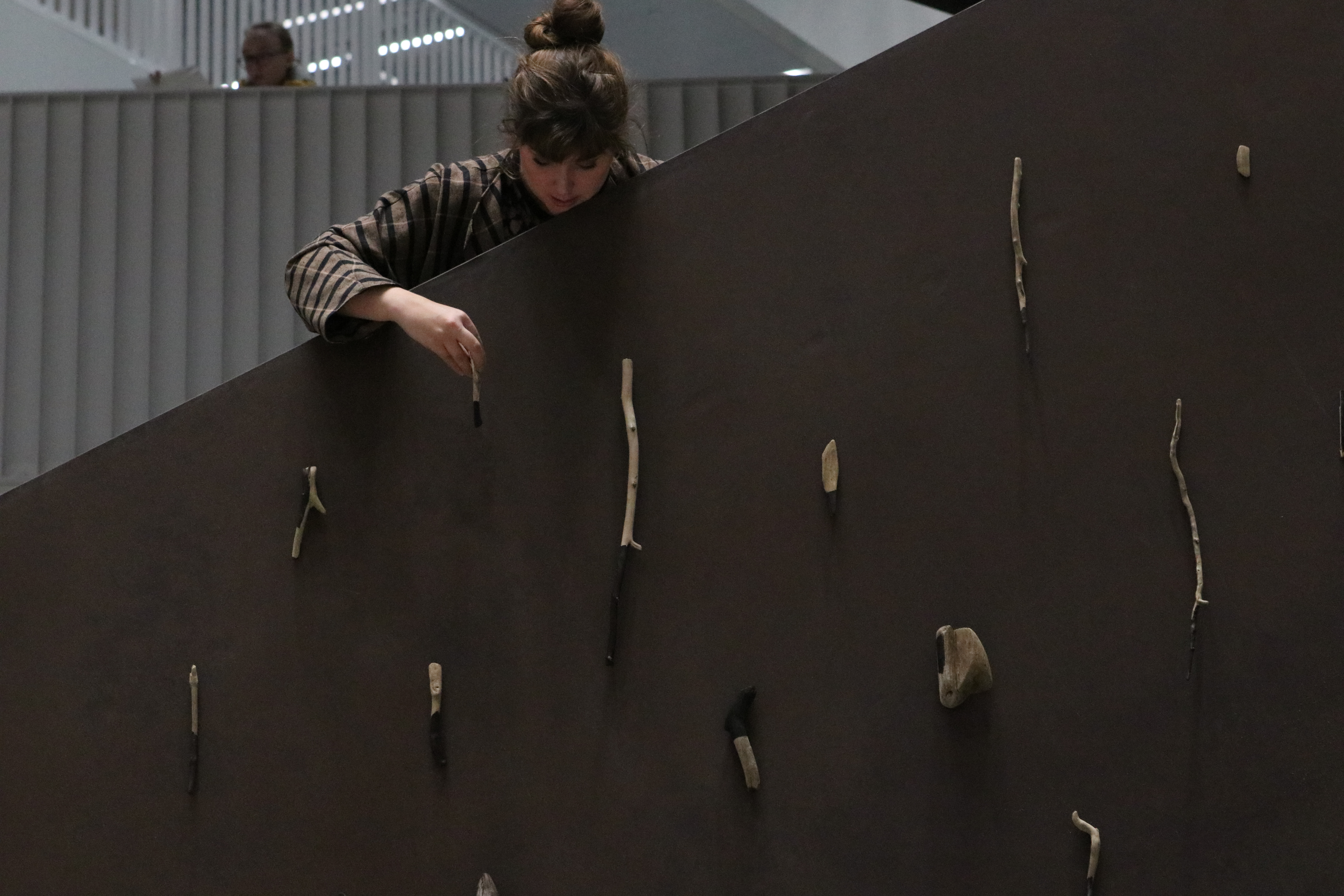 A student hangs her work from one of the stairwells in the Vare building at Aalto University