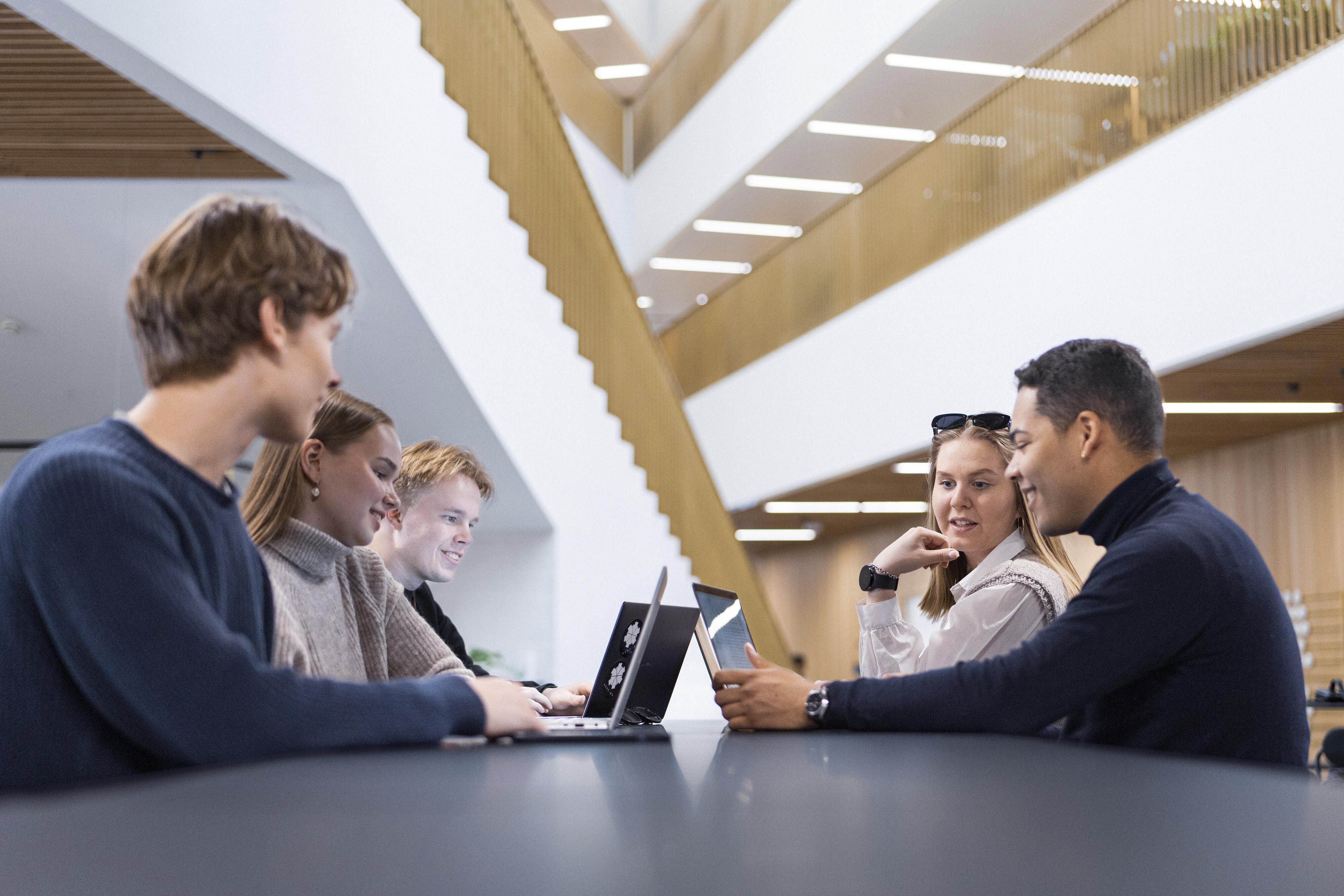 Five School of Business students doing team work