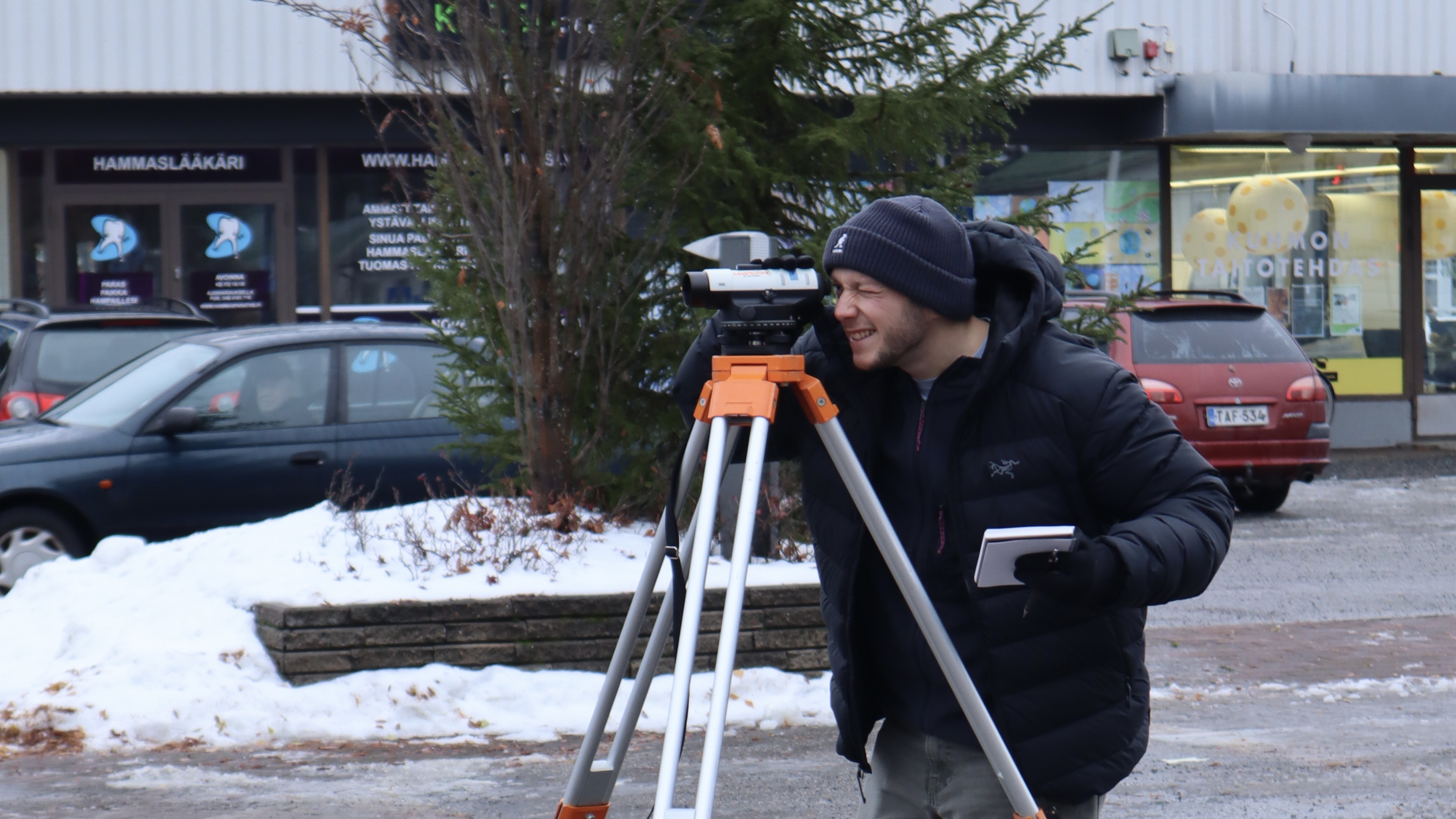 A member is doing topographic surveying