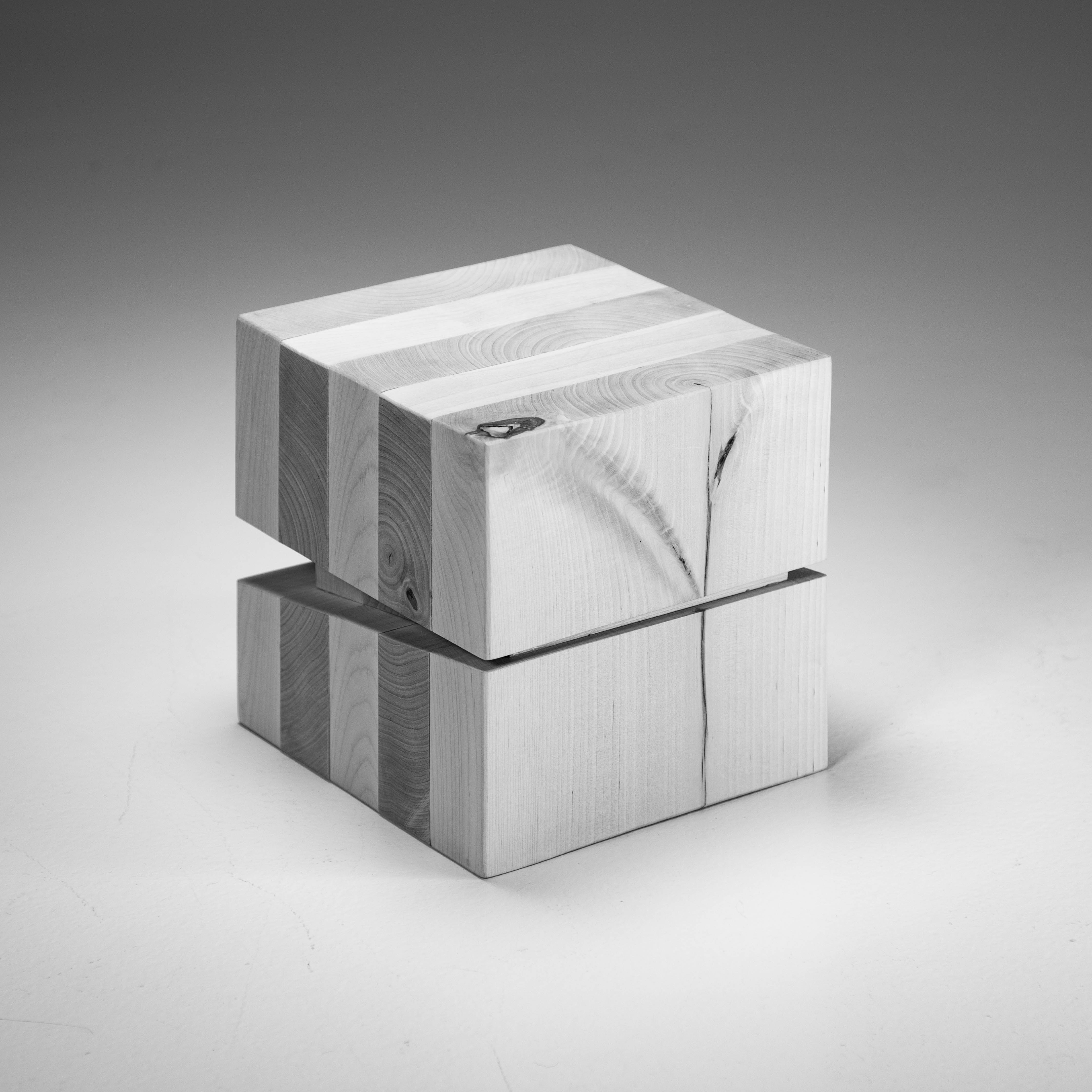 cube with alternately oriented wooden boards, and a decorative knot on one side that resembles a flower