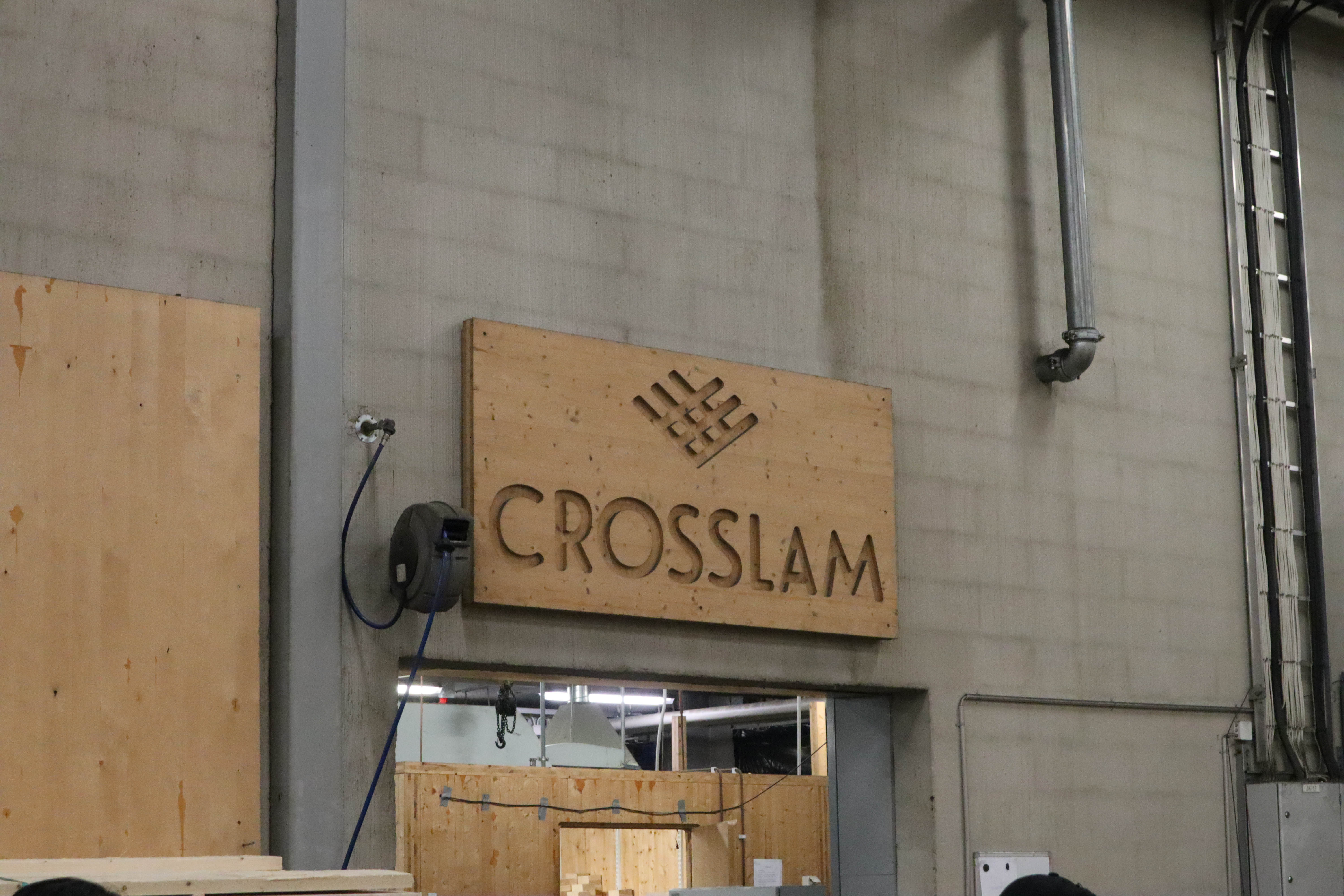A CNC cut wooden panel showing the Crosslam logo in their factory