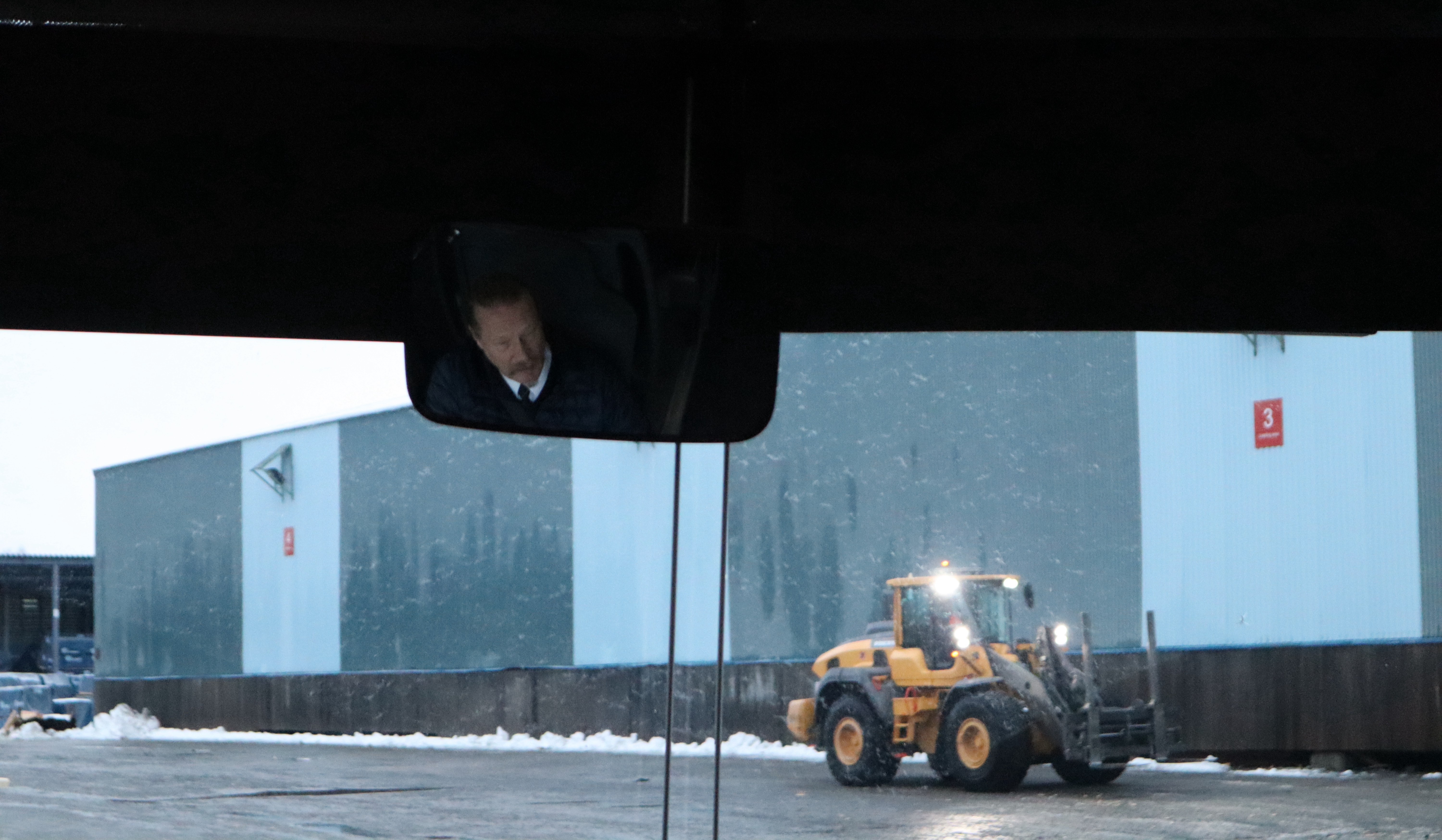 Reflection of the bus driver in the mirror