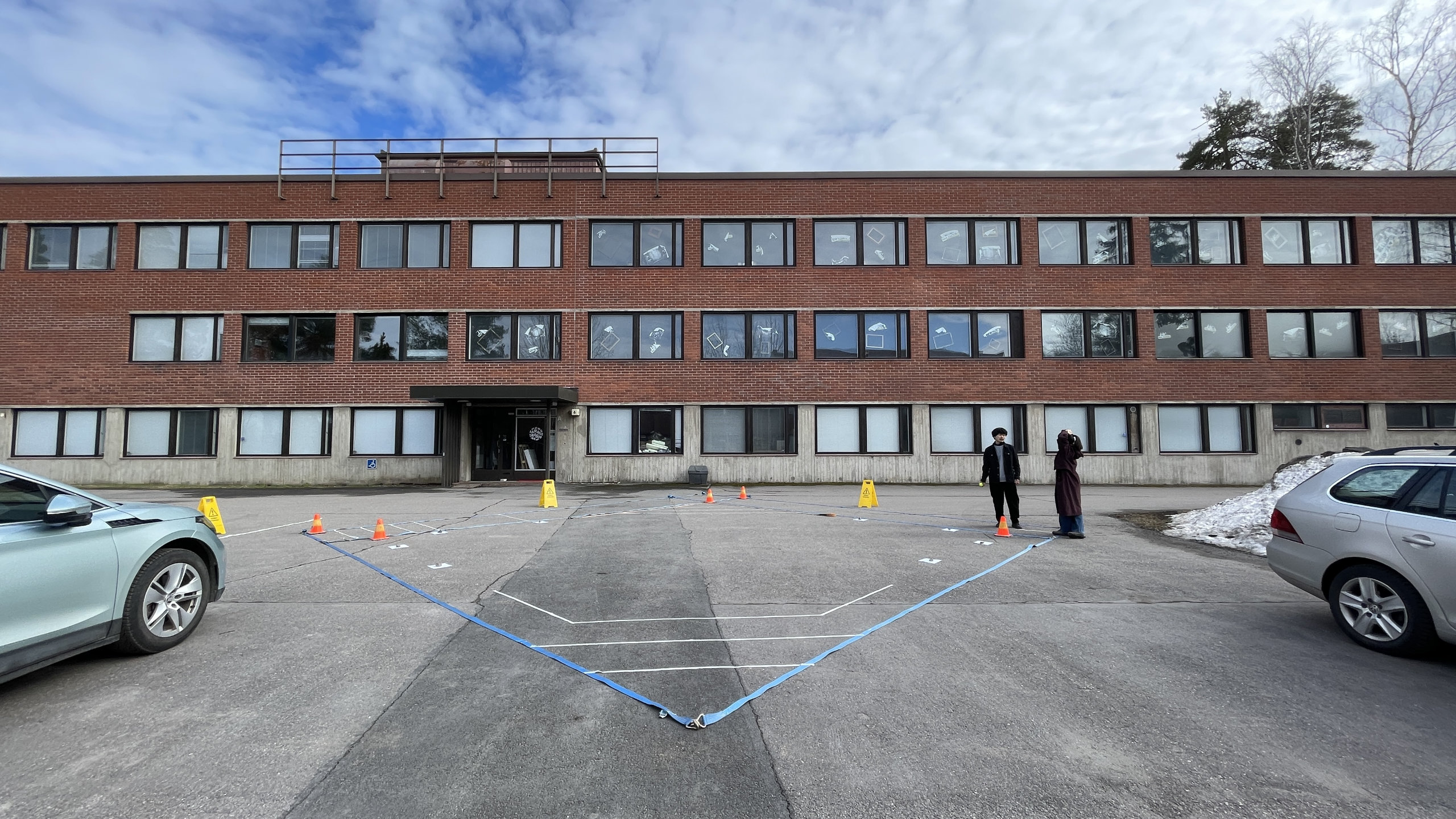 The stage layout marked with cargo straps, tape and traffic cones on a parking lot