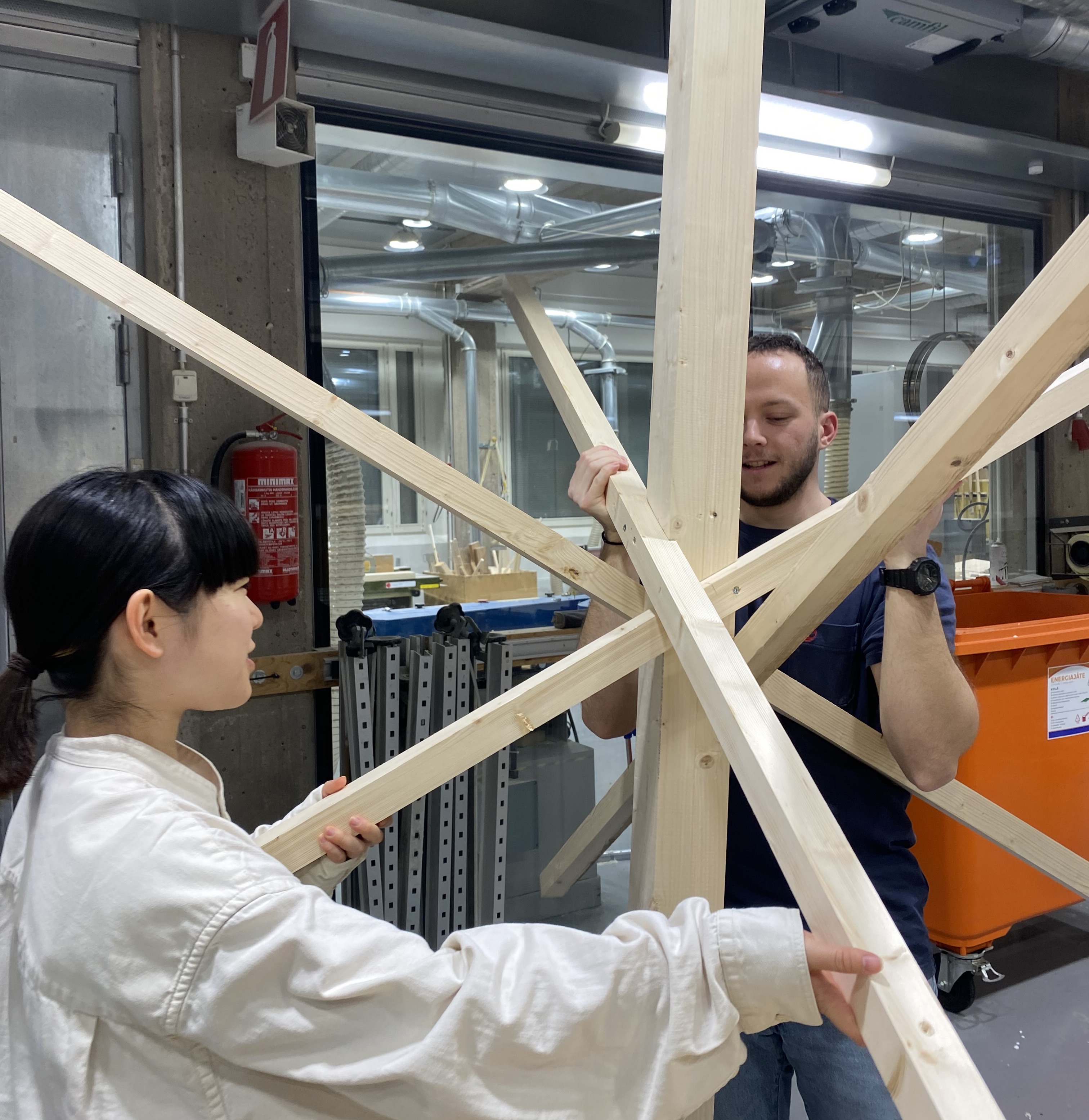 Students making mockup of wooden joint with snowflake shape