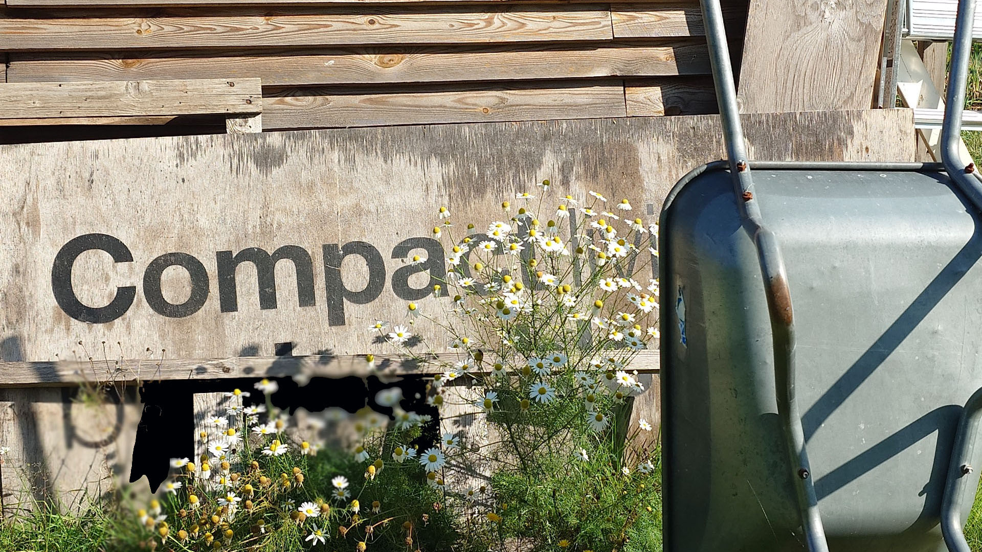 Wheelbarrow and the text Comp