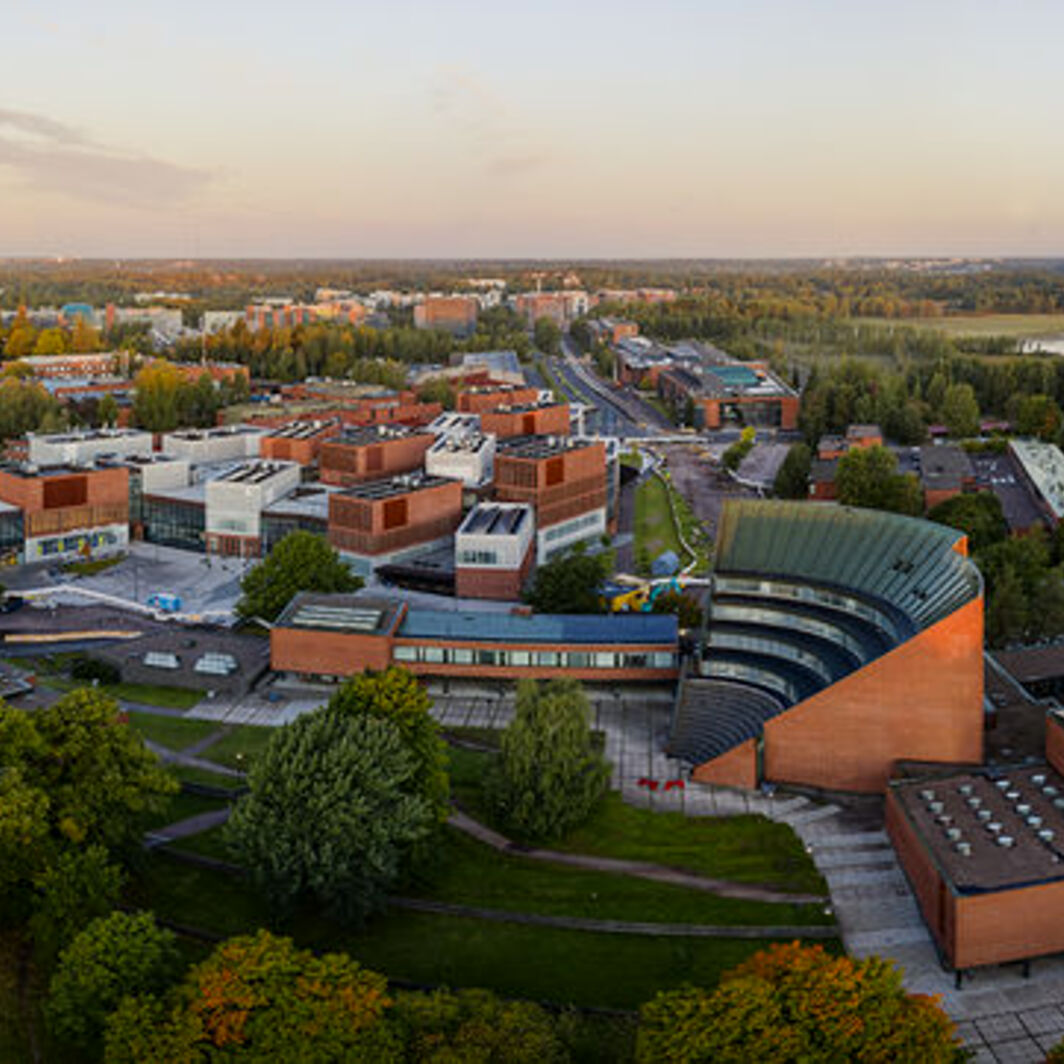 An aerial photo of the Aalto University campus at sunset.