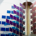 Abstract image with several small square pieces in blue, aubergine and red. Photo by Aalto University / Mikko Raskinen