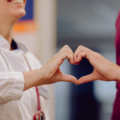 Doctor patient encounter with hands forming a heart