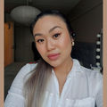 A selfie of Mimi Tran facing the camera, wearing a white shirt