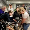 Students pull a bicycle apart