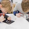 Kids using magnifying glass