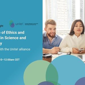 Four students sitting around a table watching a laptop. 