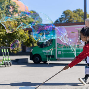 Kids playing with giant soap bubbles