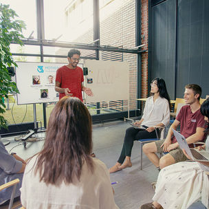 A group of students working on a presentation at Aalto Ventures Program