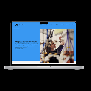 Laptop displaying a webpage from Aalto University about sustainable future with a laboratory image.