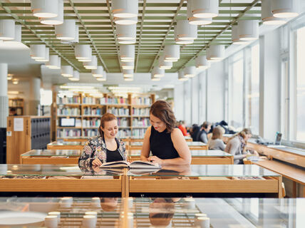 Two students at the Aalto University Learning Centre