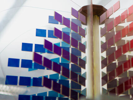 Abstract image with several small square pieces in blue, aubergine and red. Photo by Aalto University / Mikko Raskinen