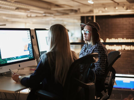 Two people working with computers
