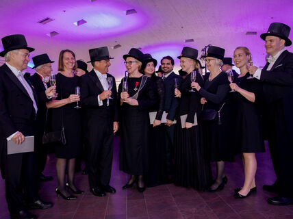 A group of doctors toasting at a Conferment party.