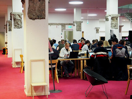 Photo from the K-floor of the Harald Herlin Learning Centre, students working at desks.