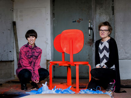 two women and chairs