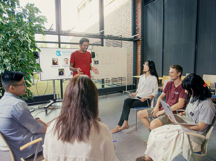 A group of students working on a presentation at Aalto Ventures Program
