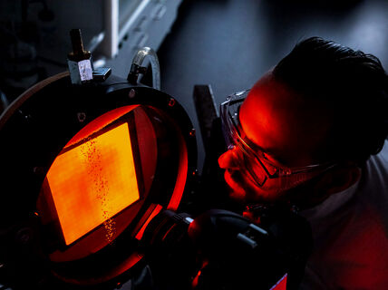 Researcher looking at a reserch device.