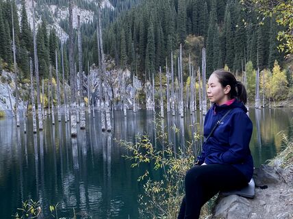 School of Business alumna Aigerim Nukekova in the forest.