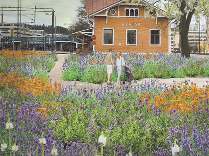 Havainnekuvassa vanhan puisen rautatieaseman ympäristö on luonnonvaraista kukkaniittyä