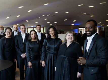 Doctors dressed in black celebrating their promotion as doctors