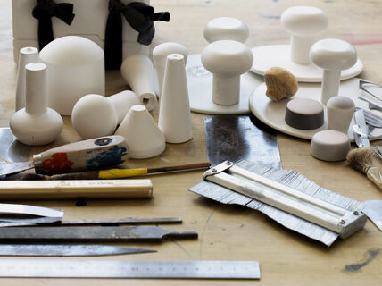 Workshop table full of tools for working with plaster and clay