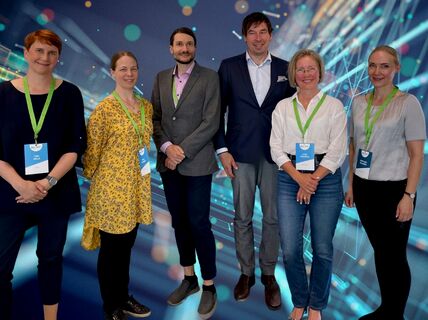 6 roundtable speakers standing together