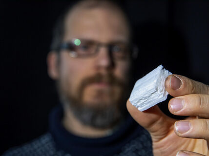 Researcher Juha Koivisto holds up a piece of the bio foam material. 