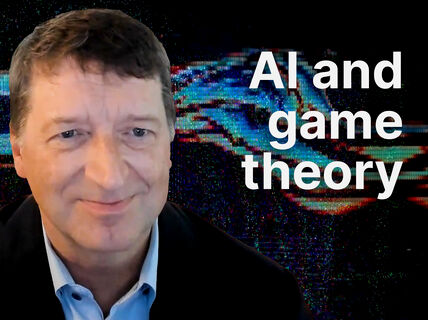 Smiling man in suit before glitchy blue and red digital backdrop, text reads “AI and game theory”.