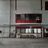 Thumbnail of Industrial warehouse interior with white walls and red-framed windows and doors. Boxes and equipment on the floor.