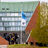 Thumbnail of Aalto 15 years blue flag floating in front of outside amphitheatre. A group of people are gathered on the steps.