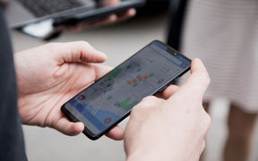 Hands holding a smartphone that displays a map application