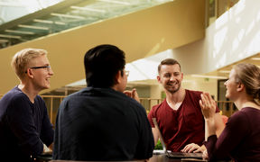 4 students sitting around table