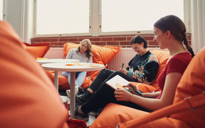 Aalto University business students doing a group work and writing post-it notes.