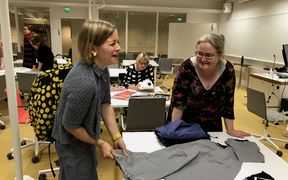 kuva ompelukerholaisista kankaiden äärellä