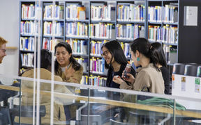 students and a book shelf