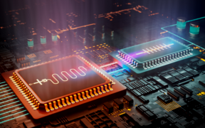 An artistic rendering of two chips on a circuit board, one is blue and the other is orange and light is emitting from their surf